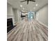 Open-concept living room and kitchen area featuring new floors and recessed lighting at 6093 Wayarer Dr, Villa Rica, GA 30180