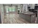 Open floorplan living room and kitchen area with fireplace and lots of natural light at 6093 Wayarer Dr, Villa Rica, GA 30180