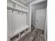 Convenient mudroom area with storage bench and hooks, leading to the home's interior at 6093 Wayarer Dr, Villa Rica, GA 30180