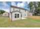 Green backyard and light green two-story home with a patio and a wooden fence at 107 Cedar Brook Dr, Canton, GA 30115