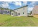 Spacious backyard with green grass and a light green home with a patio at 107 Cedar Brook Dr, Canton, GA 30115