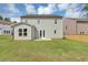 Large backyard with lush green grass, a patio, and a light green two-story home at 107 Cedar Brook Dr, Canton, GA 30115