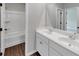 Clean bathroom featuring a double vanity with white countertops and a tub/shower combination at 107 Cedar Brook Dr, Canton, GA 30115
