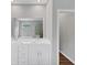 Bathroom featuring double sinks, a large mirror, and a view of the soaking tub and shower at 107 Cedar Brook Dr, Canton, GA 30115