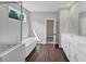 Bathroom featuring a soaking tub, shower, wood floors, and double sink vanity at 107 Cedar Brook Dr, Canton, GA 30115