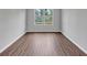 Empty bedroom showcasing hardwood floors and a view of the outdoors at 107 Cedar Brook Dr, Canton, GA 30115
