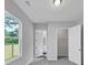 Bedroom features neutral gray walls, carpet flooring, a window, and closet doors at 107 Cedar Brook Dr, Canton, GA 30115
