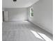 Spacious carpeted bedroom featuring a window for natural light at 107 Cedar Brook Dr, Canton, GA 30115