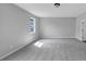 Spacious bedroom with neutral paint and carpet with one window for natural light at 107 Cedar Brook Dr, Canton, GA 30115