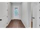 Light-filled foyer with hardwood flooring, white trim, and a glass-paneled front door at 107 Cedar Brook Dr, Canton, GA 30115