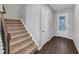 Inviting entryway with wood floors, staircase, and a view of the front door at 107 Cedar Brook Dr, Canton, GA 30115