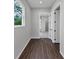 Hallway with hardwood floors that leads to other rooms with bright interiors at 107 Cedar Brook Dr, Canton, GA 30115