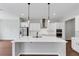 Modern kitchen with stainless steel appliances, white cabinets, and a large center island at 107 Cedar Brook Dr, Canton, GA 30115