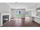 Bright and airy living room with hardwood floors, a fireplace, and access to the outdoors at 107 Cedar Brook Dr, Canton, GA 30115
