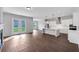 Open-concept living space with hardwood floors, a modern kitchen, and a cozy fireplace at 107 Cedar Brook Dr, Canton, GA 30115