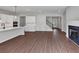 Open-concept living room with hardwood floors, fireplace, and access to modern kitchen at 107 Cedar Brook Dr, Canton, GA 30115