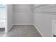 Empty walk-in closet with wire shelving, carpeted floors, and a view to the ensuite bathroom at 107 Cedar Brook Dr, Canton, GA 30115