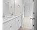 Bright bathroom featuring double vanity and stone countertops at 2432 Whites Rdg, Decatur, GA 30034