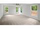 Large bedroom with plush carpeting, plenty of natural light from multiple windows, and a contemporary ceiling fan at 2432 Whites Rdg, Decatur, GA 30034