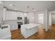 Kitchen features a central island, stainless steel appliances, ample counter space, and modern pendant lighting at 2432 Whites Rdg, Decatur, GA 30034
