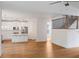 Open-concept kitchen and dining area with white cabinets, a kitchen island, and hardwood floors, perfect for entertaining at 2432 Whites Rdg, Decatur, GA 30034