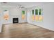 Bright living room with wood floors, a modern fireplace, and large windows offering natural light and backyard views at 2432 Whites Rdg, Decatur, GA 30034