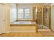 Bright bathroom with a soaking tub and glass-enclosed shower for a spa-like experience at 2810 Promenade Pl, Buford, GA 30519