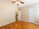 Bright bedroom featuring hardwood floors, natural light, and ensuite bathroom access at 2810 Promenade Pl, Buford, GA 30519