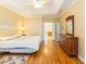 Spacious bedroom with tray ceiling, hardwood floors, and ensuite bathroom access at 2810 Promenade Pl, Buford, GA 30519