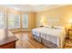 Inviting bedroom featuring hardwood floors, ceiling fan, and large windows at 2810 Promenade Pl, Buford, GA 30519