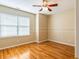Comfortable bedroom featuring hardwood floors, natural light, and neutral tones at 2810 Promenade Pl, Buford, GA 30519