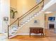 Spacious entryway with hardwood floors, stairway, and natural light creates a grand entrance at 2810 Promenade Pl, Buford, GA 30519