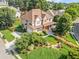 Aerial view of a two-story home with a stone and siding facade, a porch, and lush landscaping at 2810 Promenade Pl, Buford, GA 30519