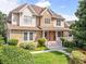 Beautiful home boasts a stone and siding exterior, lush landscaping, and a welcoming front porch at 2810 Promenade Pl, Buford, GA 30519