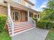 Inviting front porch with stone accents and painted steps provides a warm welcome at 2810 Promenade Pl, Buford, GA 30519