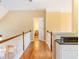 Upstairs hallway with hardwood floors and white railings provides access to other rooms at 2810 Promenade Pl, Buford, GA 30519
