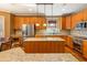 Modern kitchen with stainless steel appliances, wood cabinets, and granite countertops at 2810 Promenade Pl, Buford, GA 30519