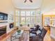 Inviting living room with fireplace, hardwood floors, and bright, natural light at 2810 Promenade Pl, Buford, GA 30519