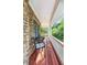 Inviting covered porch with stone accents and views of lush greenery at 2810 Promenade Pl, Buford, GA 30519