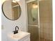 Bathroom featuring modern fixtures, shower, vanity, and round mirror at 579 Kenridge Cir, Stone Mountain, GA 30083