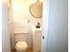 Cozy bathroom with a modern sink, toilet, and round mirror at 579 Kenridge Cir, Stone Mountain, GA 30083