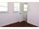 Bedroom with hardwood floors and two windows, one offering a view into the bathroom at 579 Kenridge Cir, Stone Mountain, GA 30083