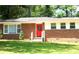 Brick home featuring a striking red front door and a row of windows at 579 Kenridge Cir, Stone Mountain, GA 30083