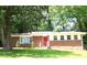 Brick home featuring a bright red front door and lush green lawn at 579 Kenridge Cir, Stone Mountain, GA 30083