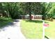 A well-maintained lawn leads to a quaint brick home with a long driveway at 579 Kenridge Cir, Stone Mountain, GA 30083