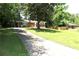 Brick home with a long driveway and spacious front yard, surrounded by trees at 579 Kenridge Cir, Stone Mountain, GA 30083