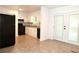 Open kitchen featuring white cabinets, black appliances, tile flooring, and a view of the back yard from the French doors at 579 Kenridge Cir, Stone Mountain, GA 30083