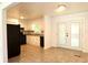 Open kitchen featuring white cabinets, black appliances, tile flooring, and a view of the back yard from the French doors at 579 Kenridge Cir, Stone Mountain, GA 30083