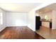 Bright living room with hardwood floors leading into a kitchen featuring white cabinets at 579 Kenridge Cir, Stone Mountain, GA 30083