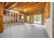 Unfinished basement with concrete walls, wood frame, exposed ceiling, and walkout double doors, ready to be customized at 65 Millennial Ct, Lawrenceville, GA 30045